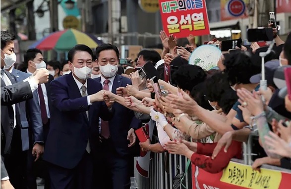 윤석열 대통령이 26일 대구 서문시장을 방문해 시민들과 인사하고 있다.